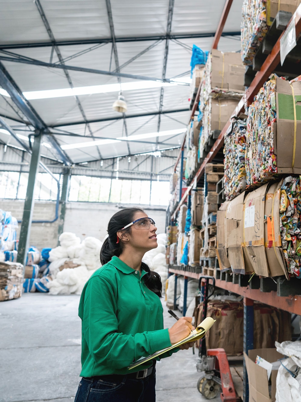 Une employée analyse la gestion des déchets dans un entrepôt